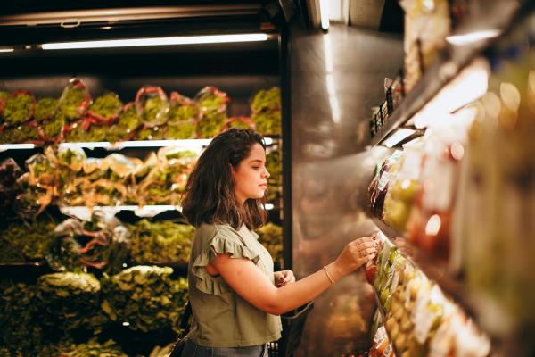 A woman looking at fresh produce in a supermarket